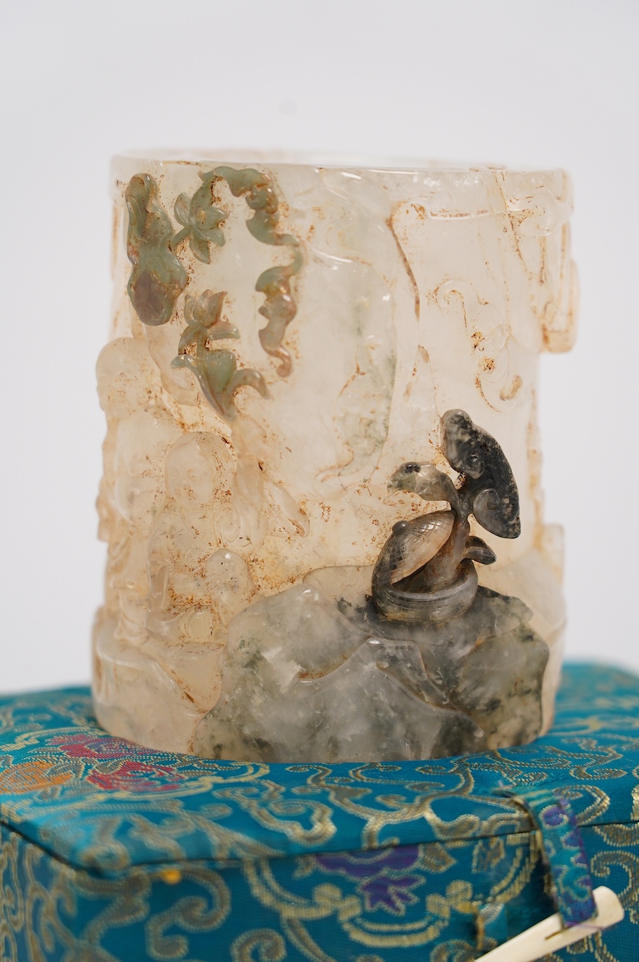 A Chinese quartz brushpot carved with figures before a landscape, cased, 14cm high. Condition - good